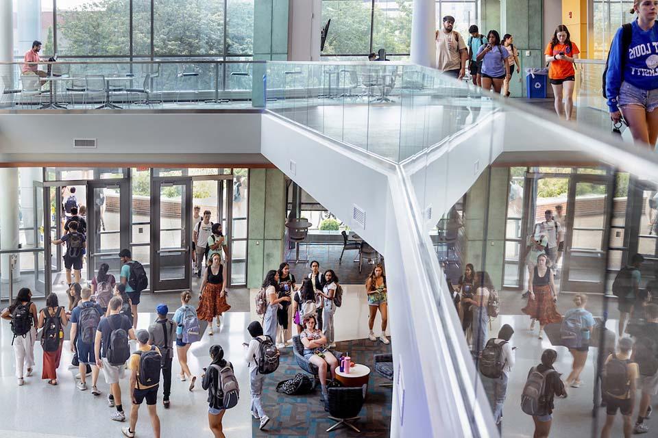 Students walk back and forth in the lobby of the Science and Engineering Building.